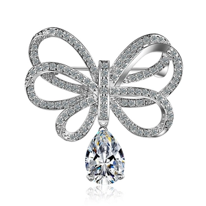 Broche nœud élégante avec pavé de zircons et grand pendentif en cristal en forme de poire