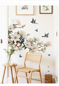 Detail of floral wall decals featuring white magnolia blossoms and blue birds on white wall