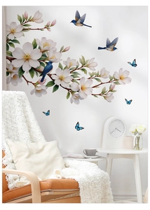 Detail showing white magnolia flowers and blue birds wall stickers in a cozy living room