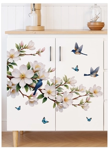 Detail showing blue bird and magnolia flower decals on a white cabinet door surface