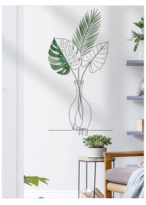 Macro detail of Nordic monstera leaf wall decal with minimalist line art vase and happy text