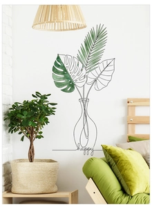 Detail of geometric monstera leaf wall decal with green accents on a white home wall