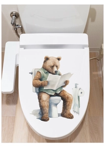 Detail of cute bear reading newspaper sticker on white toilet lid with waterproof finish