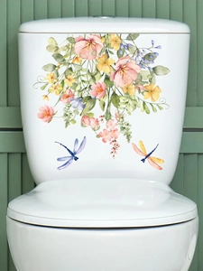 Detail showing watercolor pink floral toilet stickers with vibrant dragonflies on white ceramic