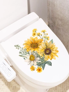 Detail of sunflower and daisy flower stickers applied on a modern white toilet lid