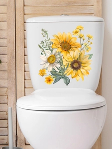 Detail of floral wall stickers with sunflowers and daisies on a ceramic toilet tank