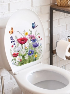 Detailed view of floral PVC decals with red flowers and butterflies on a white toilet lid