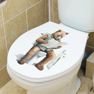 Waterproof toilet lid sticker featuring a cute brown bear reading a newspaper