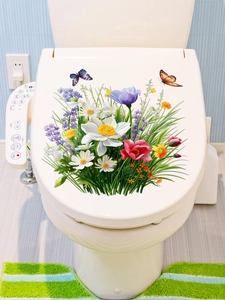 Detailed view of colorful lily and butterfly floral decals on a white toilet lid cover
