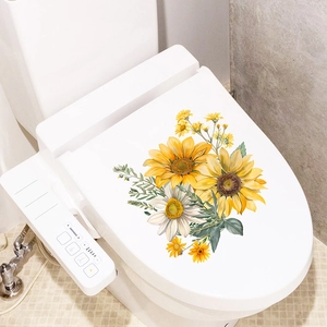 Floral sunflower and daisy toilet lid decals on white bathroom fixtures with green leaves