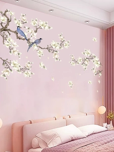 Detail of magnolia blossom wall decals with blue birds in a cozy bedroom setting