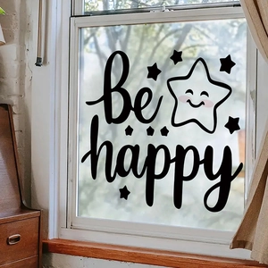 Detail of 'be happy' wall sticker with smiling star on window glass background