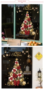 Detailed close-up of decorative Christmas tree window stickers with festive red bows and gold stars