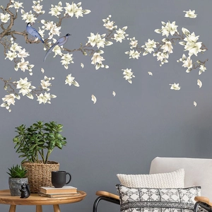 Elegant white magnolia wall decal with blue birds on minimalist dark gray background wall