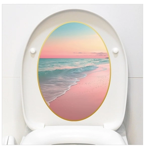 Detail of oval toilet lid sticker featuring a pink beach sunset with elegant gold trim