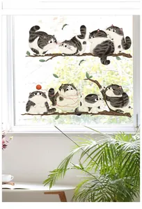 Detail of cartoon cat wall stickers showing tabby kittens playing on tree branches with yarn