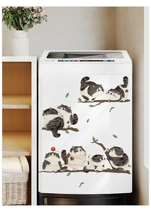 Detailed view of cute cartoon cat wall decals applied on a white washing machine panel