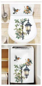 Detailed view of floral wall decals featuring vintage lampposts and birds in bathroom