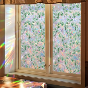 Detailed close-up of 3D iridescent window film with green eucalyptus leaf patterns