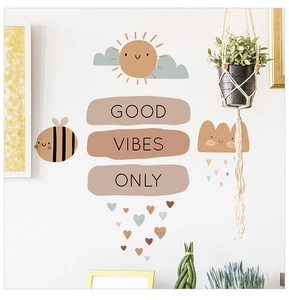 Detail of Good Vibes Only wall stickers with cartoon sun, bees, and hearts for nursery décor