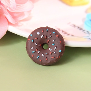 Macro shot of realistic chocolate resin donut with colorful sprinkles and fine texture