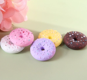 Detailed view of five colorful resin mini donuts for DIY phone cases and keychains