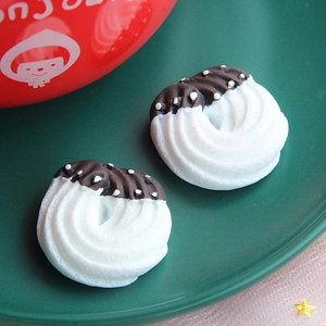 Detailed close-up of cream and chocolate resin donuts for DIY phone case crafts