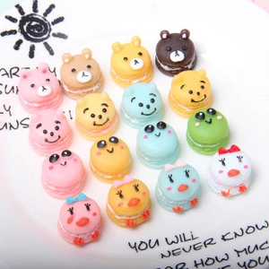 Detailed macro view of assorted colorful resin macaron charms with cartoon faces