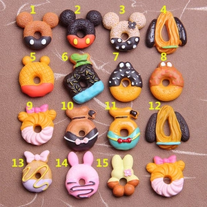 Detailed macro view of assorted cartoon character resin donut charms for DIY jewelry crafts