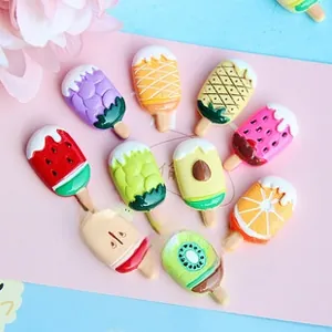 Flat lay of colorful miniature resin fruit popsicle charms for DIY crafts and accessories