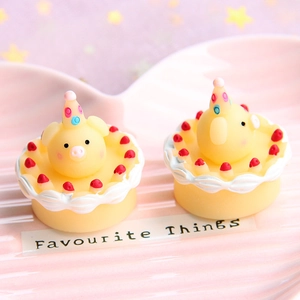 Cute resin miniature pig cakes on a heart tray with soft pink and purple star bokeh
