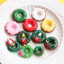 Macro detail of miniature resin Christmas donuts and wreaths for festive DIY crafts
