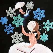 Detail view of winter theme resin sticker with girl reading books and magical snowflakes