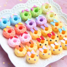 Macro view of colorful resin donut charms with bow details for DIY crafts and decor
