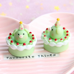 Detailed macro shot of miniature mint green pig resin figurines on a pink plate