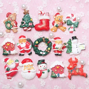 Flat lay of colorful Christmas resin charms including Santa, snowman, and reindeer figures