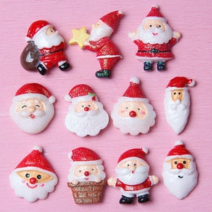 Flat lay of Santa Claus resin charms with glitter detail for DIY crafting and decor