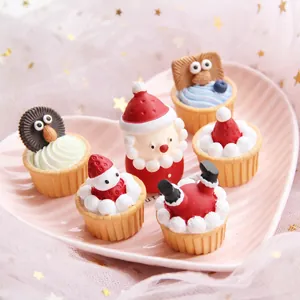 Miniature Christmas resin cupcakes and Santa figurine set on a pink heart plate