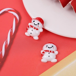 Detail of Christmas resin snowmen with red hats and scarves for DIY holiday craft projects