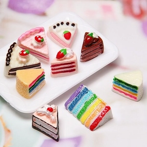 Macro shot of nine miniature resin cupcake slices with realistic cream and fruit details
