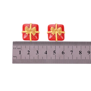 Pair of red resin gift box charms with gold glitter and bow for DIY Christmas crafts