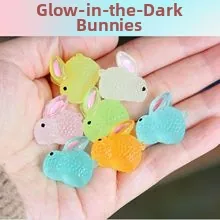 Close-up of colorful luminous resin rabbits in various matte finishes held in hand