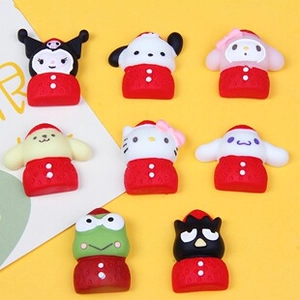 Macro view of Sanrio character resin charms for DIY craft accessories in festive red suits
