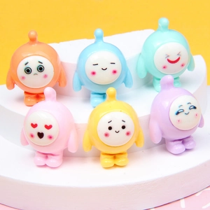Colorful resin cartoon egg figurines in 6 vibrant colors on a multi-tier white display