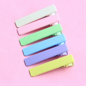 Detail view of 6 colorful matte rectangle hair clips in pastel macaron tones