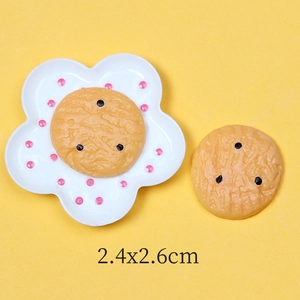 Detail view of resin fake cookie charms on a mini plate for DIY phone case crafting