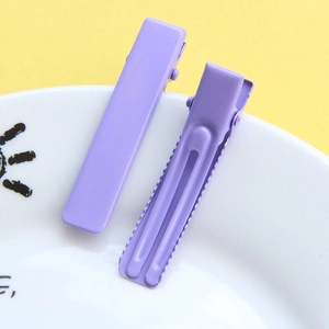 Detail of purple alligator hair clips with smooth finish and reinforced groove design