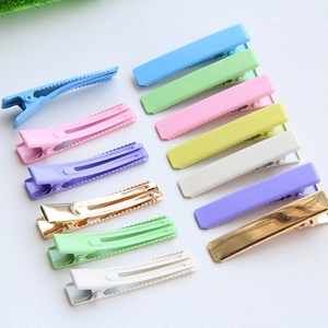 Set of 4.8cm macaron color and gold plated metal duckbill hair clips on white background