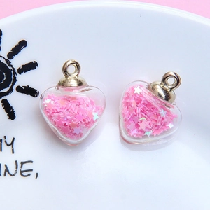 Heart-shaped glass pendant with pink star sequins and golden metal ring for DIY jewelry