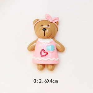 Detailed view of a brown resin bear DIY charm wearing a pink dress, size 2.6x4cm